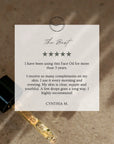 A promotional review card for a facial oil, styled over a close-up of a black dropper bottle and a glass dropper containing golden oil on a textured beige surface. The card reads 'The Best' with five stars and a testimonial signed Cynthia M.