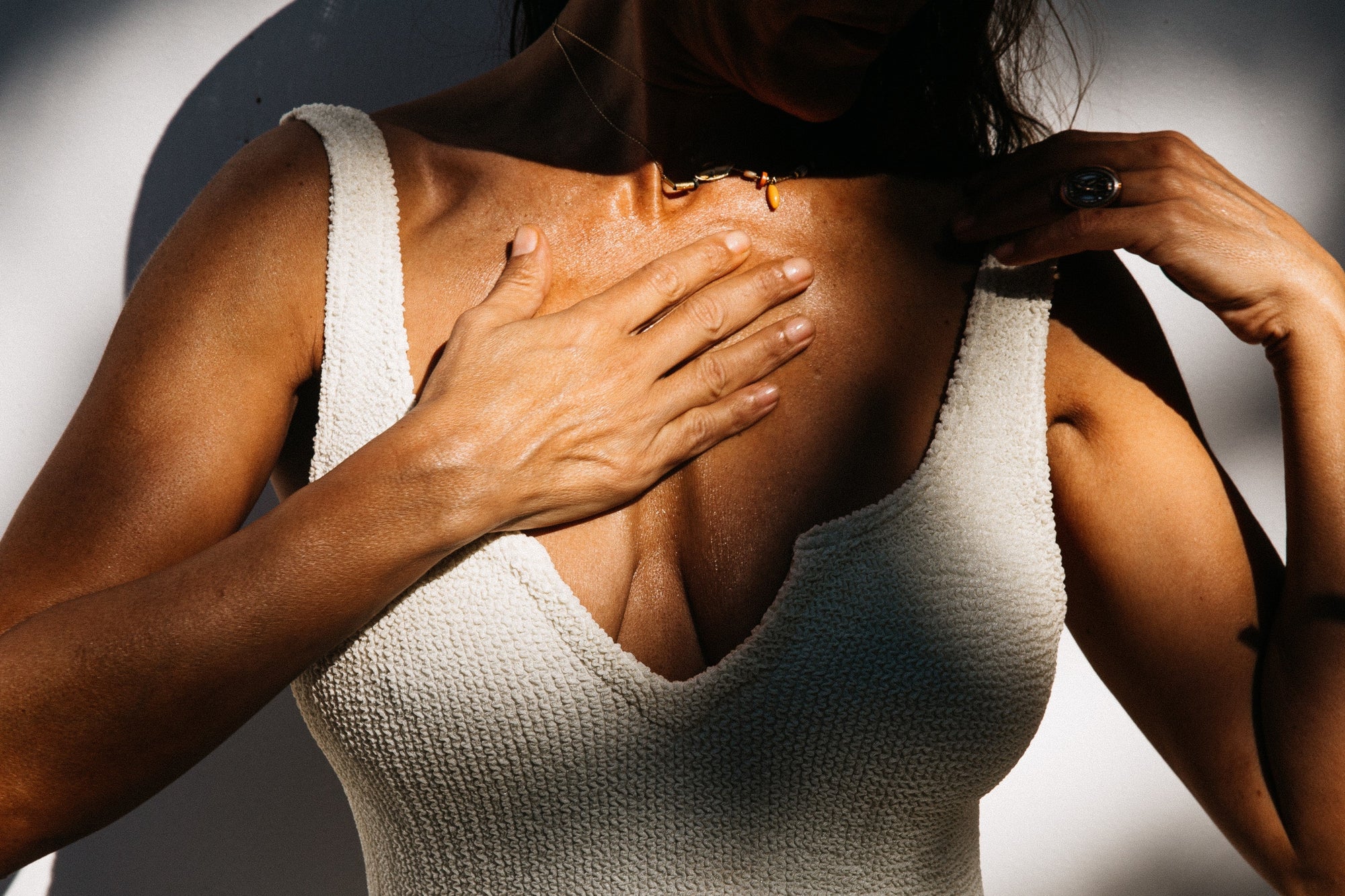 Woman pointing towards her heart, symbolizing inner healing and spiritual awakening through meditation
