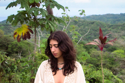 Woman standing alone in a peaceful forest, symbolizing spiritual self-reliance and connection with inner voice
