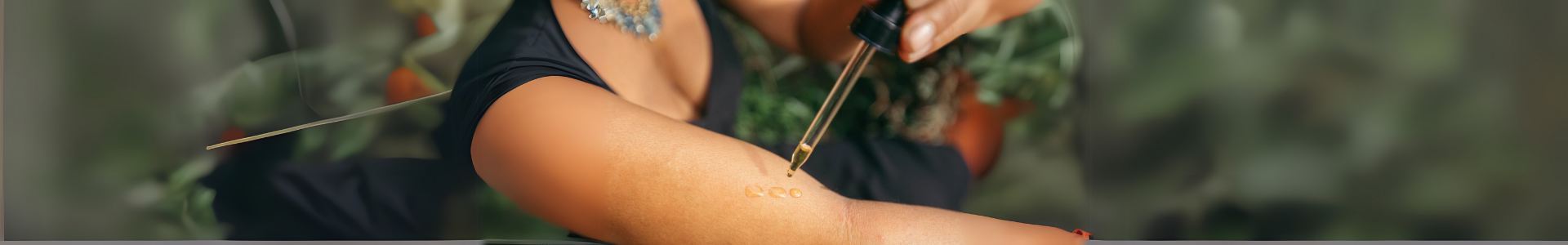 Woman applying Osi Oil to arm during Abhyanga self-massage ritual for skincare and emotional wellness