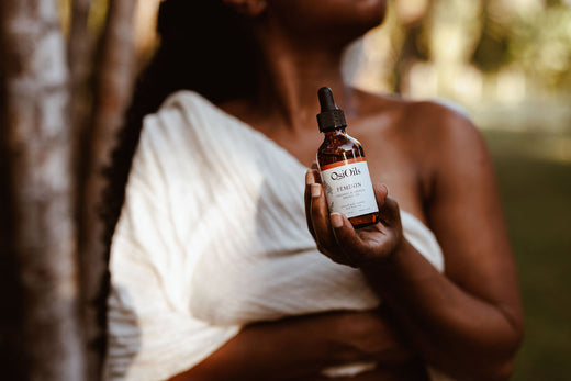 Woman holding Osi Oils bottle, embracing the power of Ayurveda for wellness and self-care