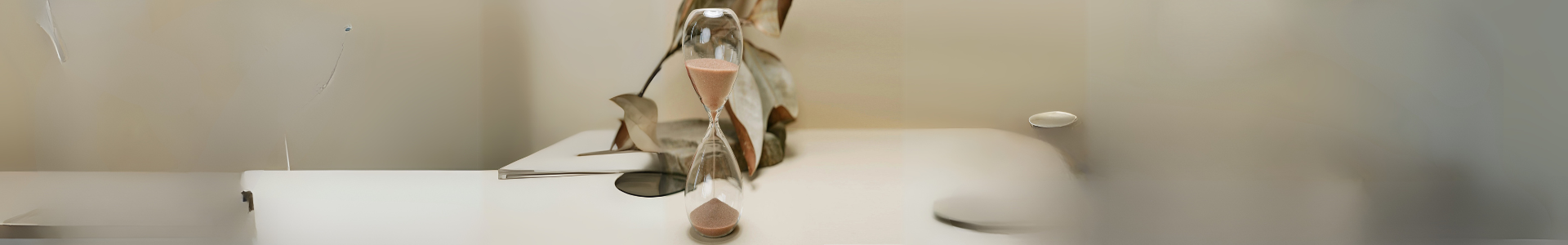 Sand clock with sand dripping, symbolizing the passage of time and mindfulness
