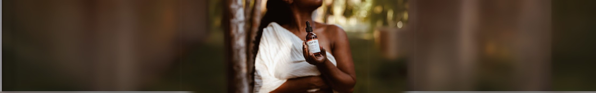 Woman holding Osi Oils bottle, embracing the power of Ayurveda for wellness and self-care