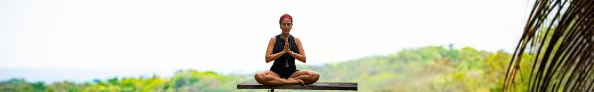 Woman practicing yoga in the mountains during travel