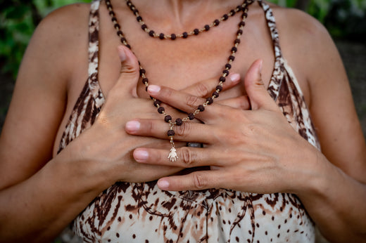 Woman placing hand on heart, symbolizing body intuition, mindfulness, and inner wisdom