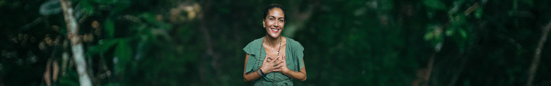 Woman gently placing her hands over her heart, symbolizing self-love, healing, and the calming effects of Ayurvedic practice